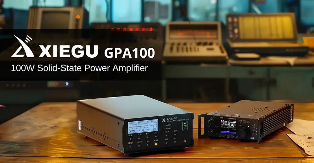 XIEGU GPA100 100W Solid-State Power Amplifier on a wooden surface with a blurred background of electronic equipment.