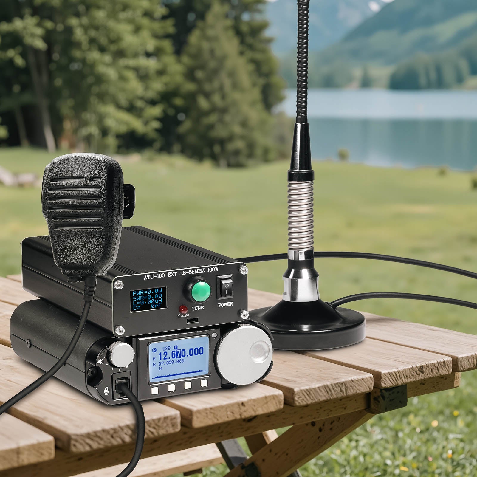Radio communication equipment on a wooden table with a scenic background of trees and a lake.
