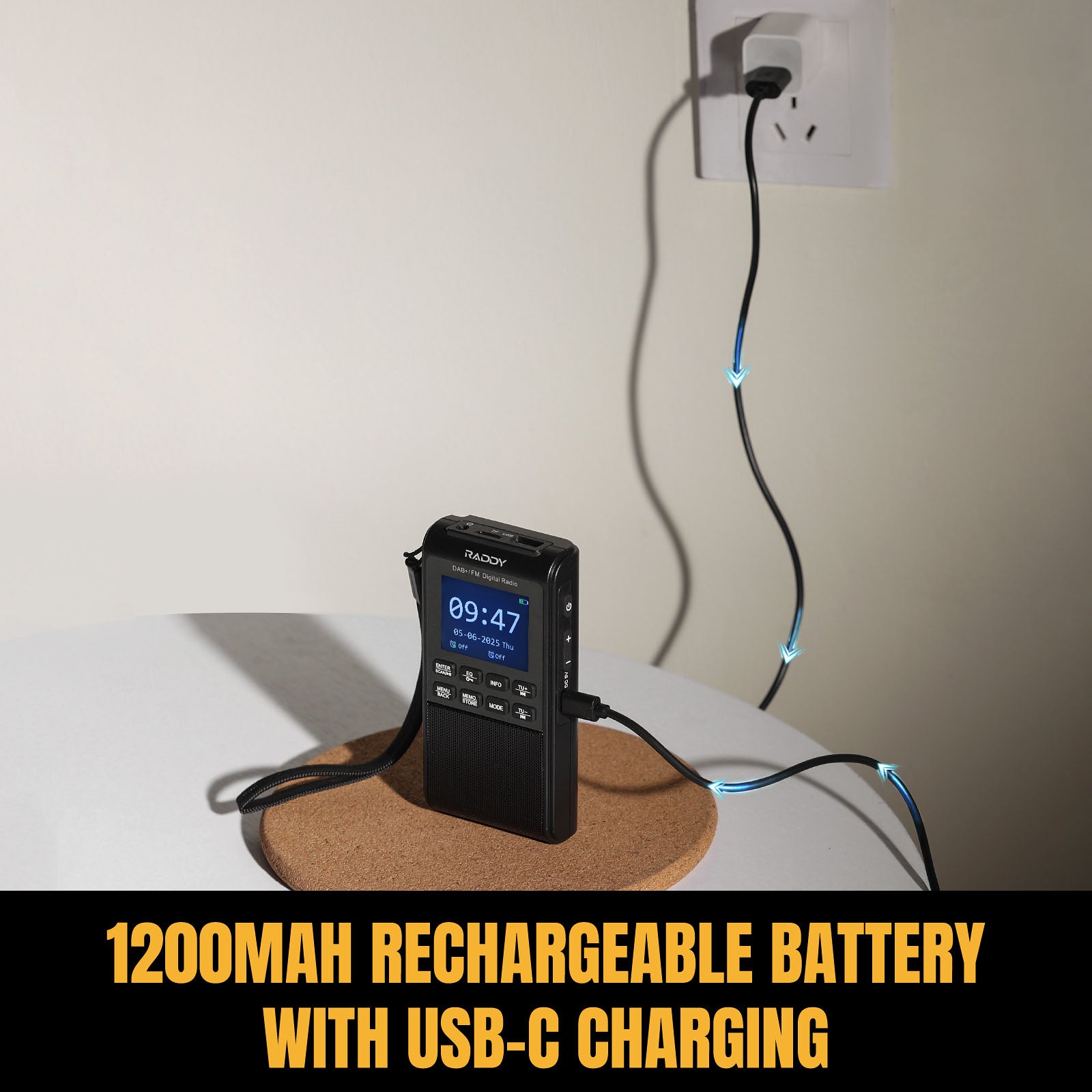 Black portable device with Raddy RD939 digital display on a cork coaster, plugged into a wall socket with text '1200mAh rechargeable battery with USB-C charging'.