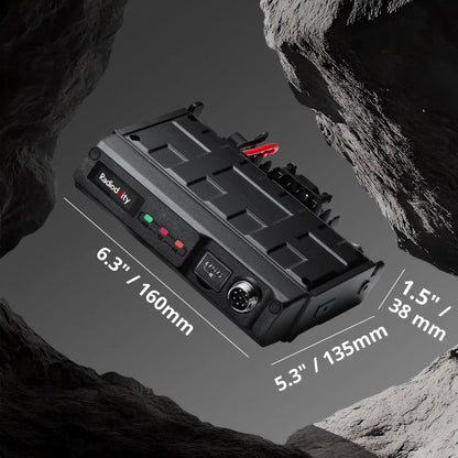 Black battery pack with dimensions labeled on a rocky background