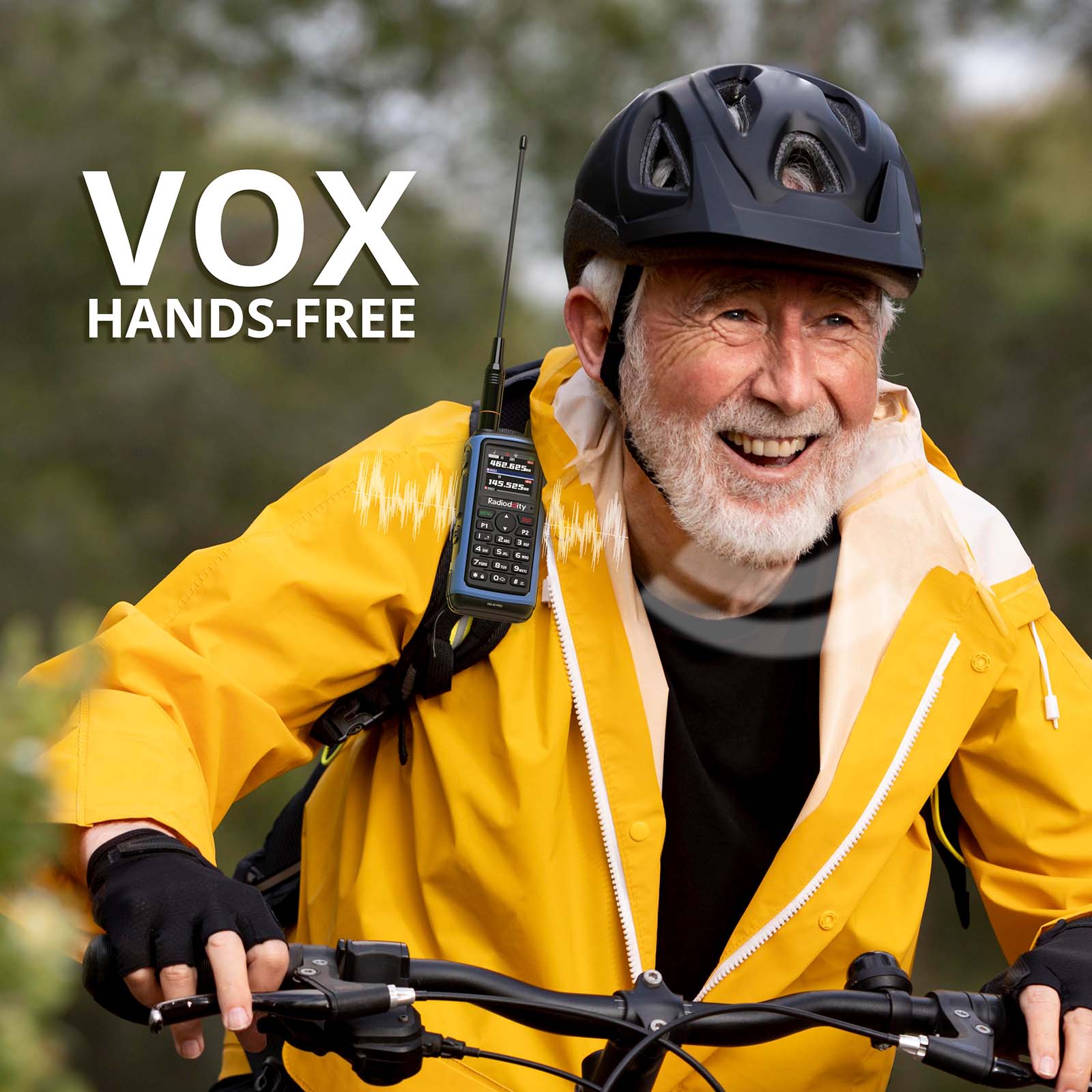 Man riding a bicycle with a VOX hands-free communication device, wearing a yellow jacket and helmet.
